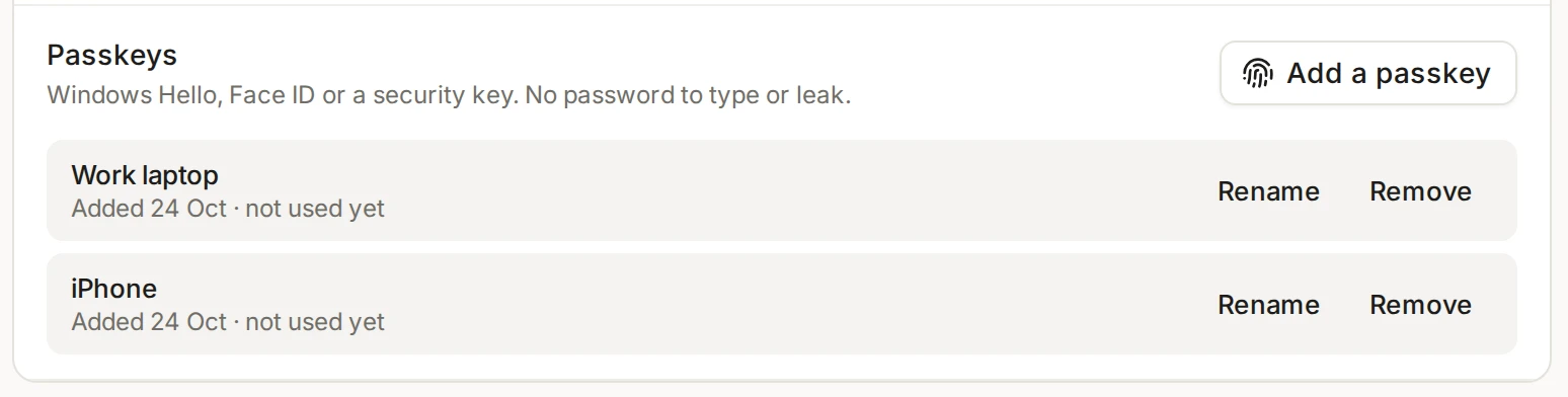 The Passkeys row in Security with two passkeys listed, Work laptop and iPhone, each with Rename and Remove buttons.